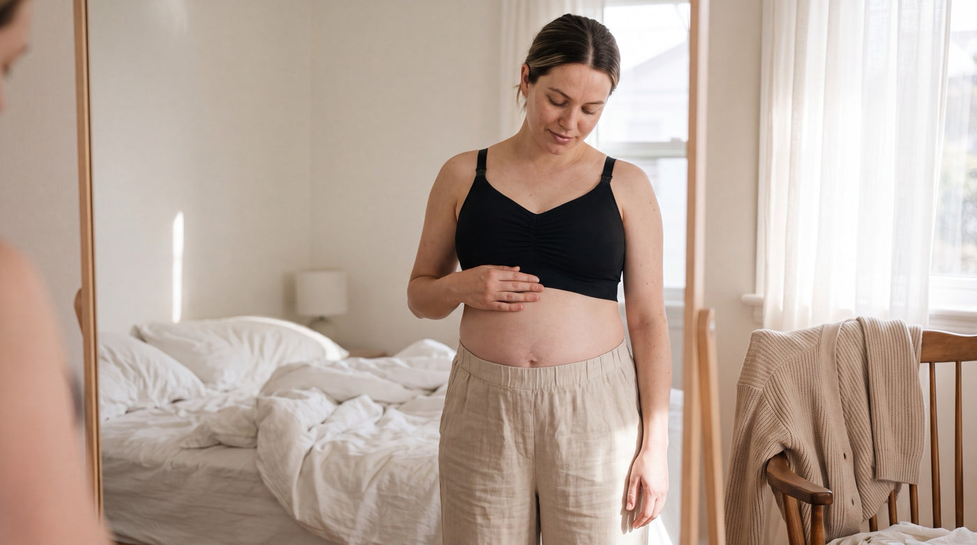 Folded nursing bras on a bed with a soft morning light from the window